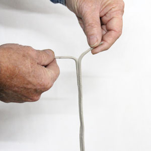 Separate caulk into two pieces so it can be placed around ventilator's exterior and interior tubes